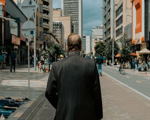 People walking dynamic and naturally along a pedestrian sidewalk in a Colombian business district