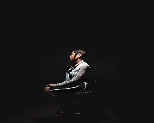 Close-up of a person taking a light stretching break while sitting on an office chair